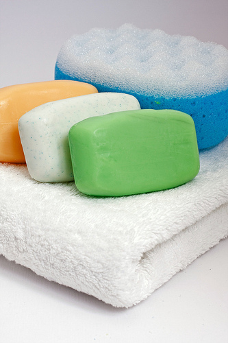 Colorful bars of soap on white towel